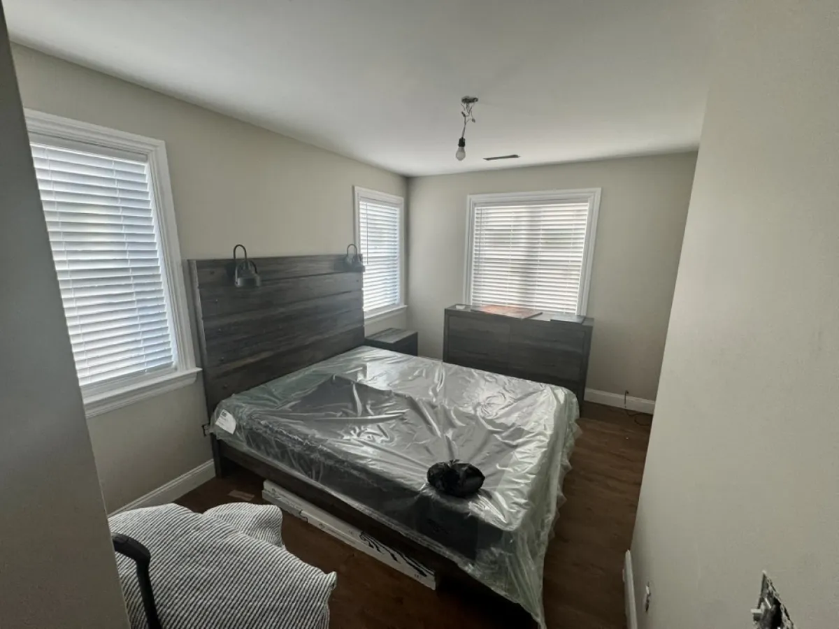 A tranquil bedroom with a comfortable bed, nightstand, and soft natural light streaming through the windows. The decor is subtle yet inviting, suggesting a peaceful sanctuary perfect for restful nights after days of adventure.